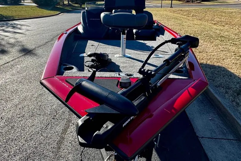Slide: The Image of 2026 Tracker Pro Team 175 Crappie Edition boat with red exterior on pavement. - 3