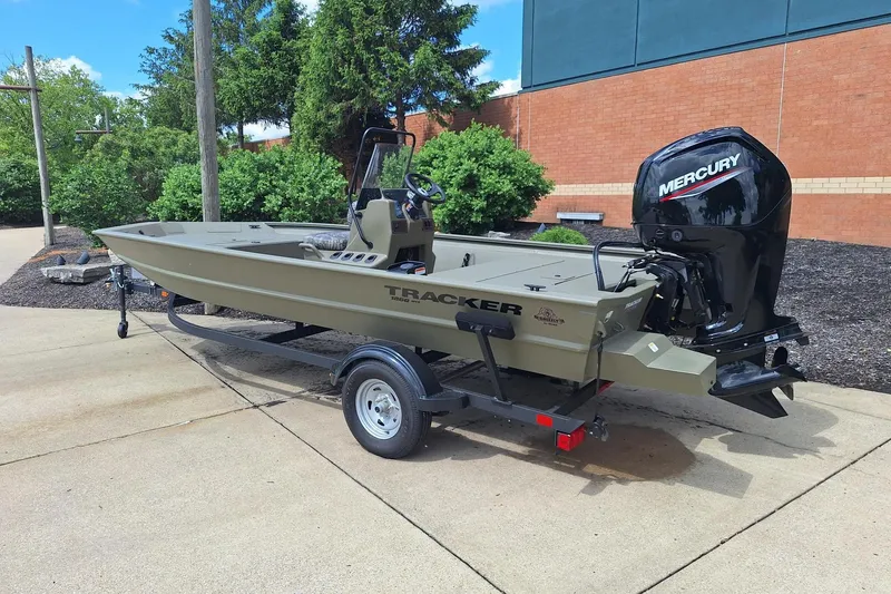 The Image of 2026 Tracker Grizzly 1860 CC boat with Mercury engine on trailer, parked outdoors. - 0