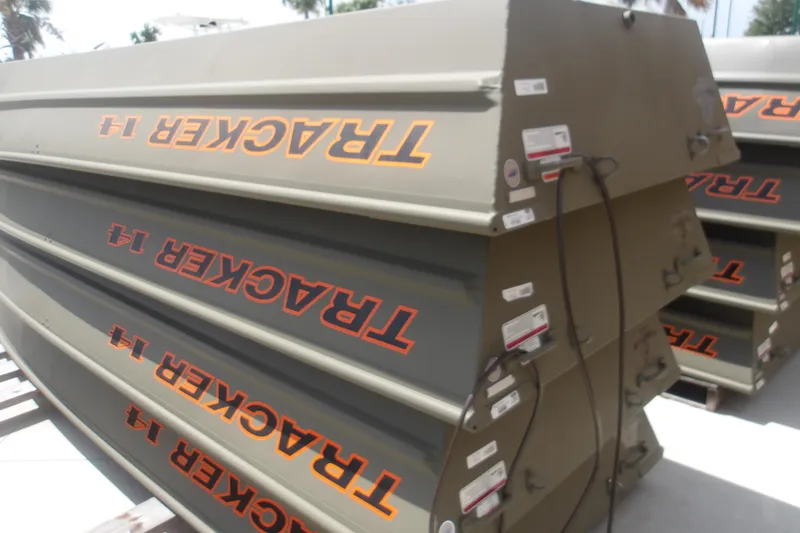 Slide: The Image of 2026 Tracker Grizzly 14 Jon boats stacked, showcasing durable design and branding. - 3