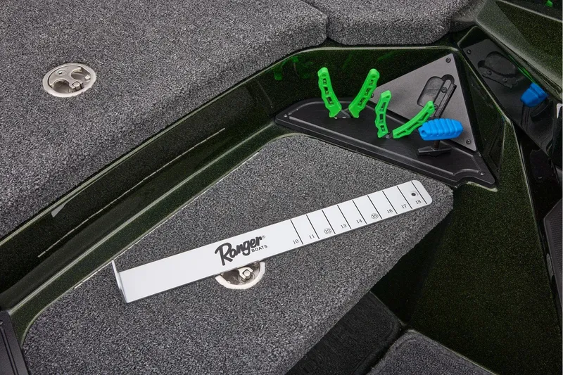 Slide: The Image of 2026 Ranger Z521 boat deck with open storage compartment, featuring a Garmin device. - 25