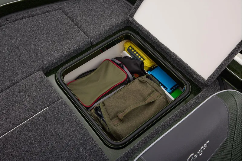 Slide: The Image of 2026 Ranger Z521 boat deck with carpeted storage compartments and seating. - 57