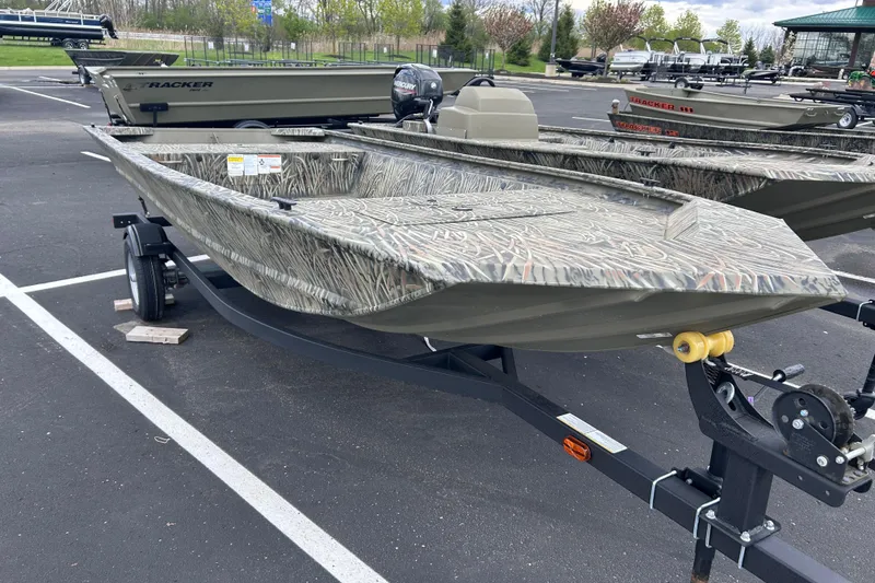 Slide: The Image of 2026 Tracker Grizzly 1648 Utility boat on trailer in parking lot. - 2