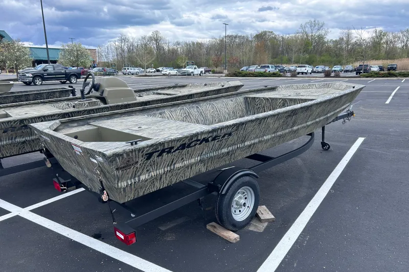 Slide: The Image of 2026 Tracker Grizzly 1648 Utility boat in parking lot, featuring camouflage design. - 6