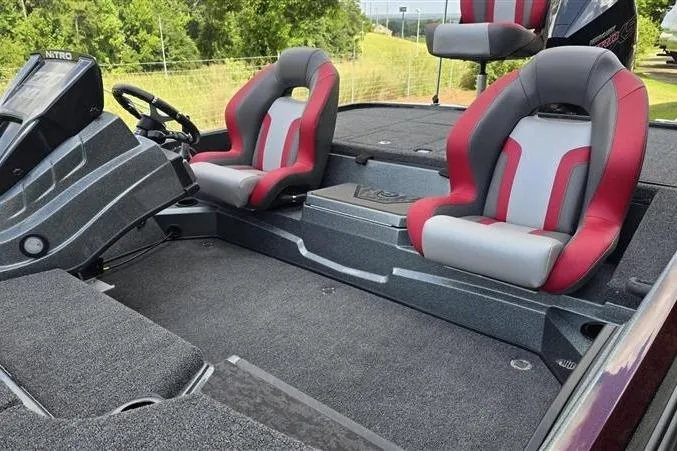 Slide: The Image of 2026 Nitro Z20 XL Pro boat interior with red and gray seats, steering console, and carpeted flooring. - 8