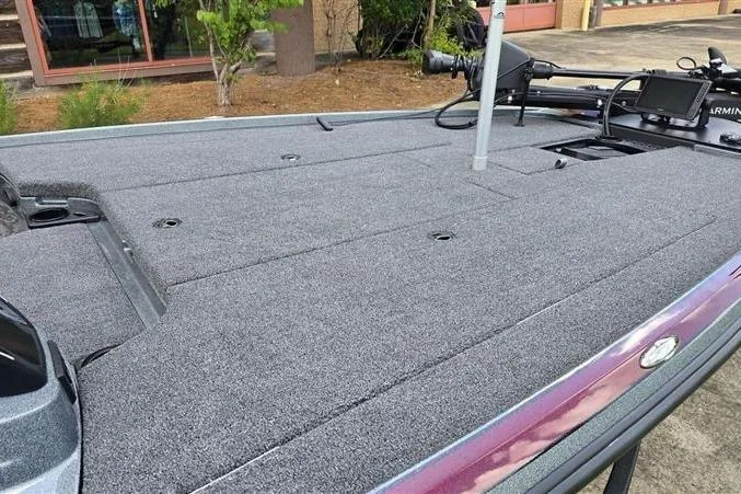 Slide: The Image of 2026 Nitro Z20 XL Pro boat deck with carpeted surface and fishing equipment. - 9