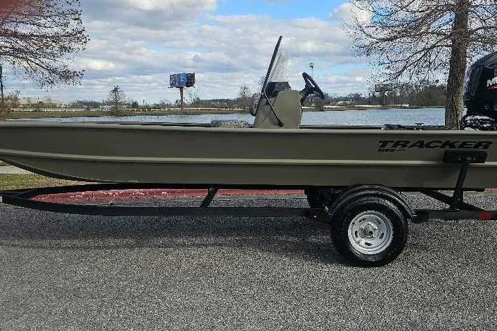 The Image of 2026 Tracker Grizzly 1860 CC boat on trailer by a lake. - 0