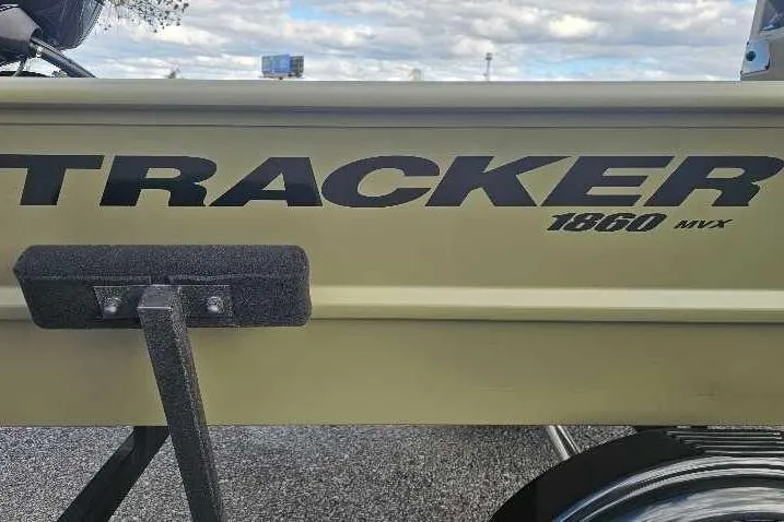 Slide: The Image of 2026 Tracker Grizzly 1860 CC boat side view with logo and trailer. - 2