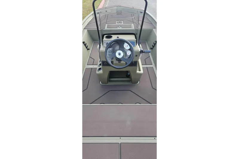 Slide: The Image of 2026 Tracker Grizzly 1860 CC boat console with steering wheel and dashboard controls. - 3