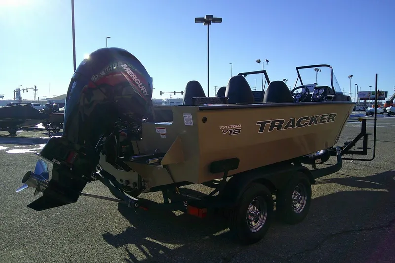 Slide: The Image of 2026 Tracker Targa V-18 Combo boat with Mercury outboard engine in a parking lot. - 83