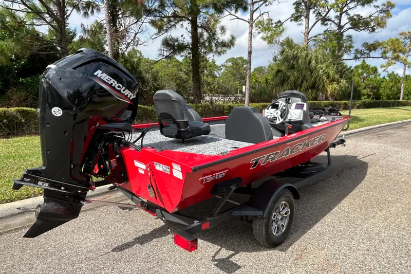 Slide: The Image of 2026 Tracker Pro Team 175 boat with Mercury engine on trailer, parked outdoors. - 5