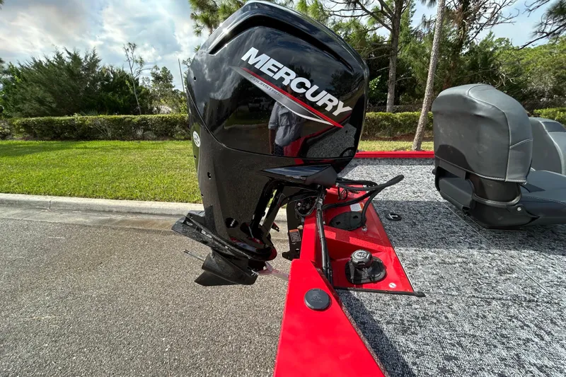 Slide: The Image of 2026 Tracker Pro Team 175 with Mercury outboard motor, parked on a sunny day. - 6