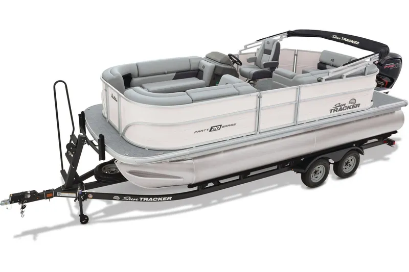 Slide: The Image of 2026 Sun Tracker Party Barge 20 DLX pontoon boat on trailer, parked outdoors. - 4