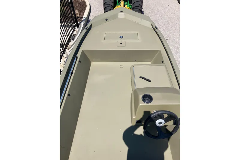 Slide: The Image of 2026 Tracker Grizzly 1648 SC boat interior with steering wheel and storage compartments. - 6