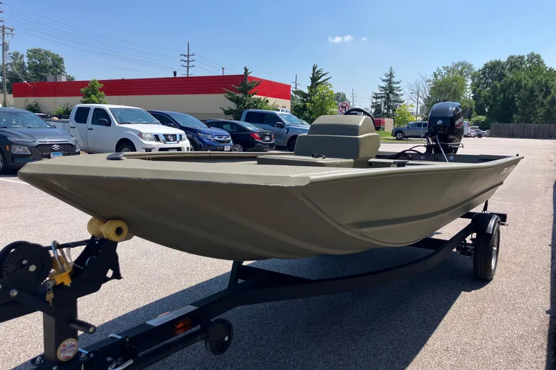 Slide: The Image of 2026 Tracker Grizzly 1648 SC boat on trailer in parking lot, sunny day. - 4