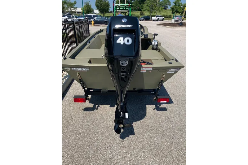 Slide: The Image of 2026 Tracker Grizzly 1648 SC boat with Mercury 40 outboard motor, parked outdoors. - 3