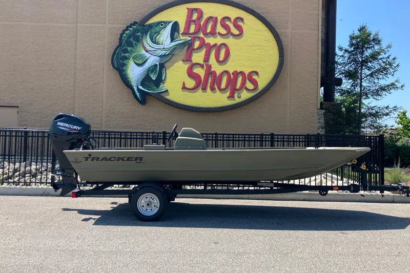 The Image of 2026 Tracker Grizzly 1648 SC boat on trailer outside Bass Pro Shops. - 0