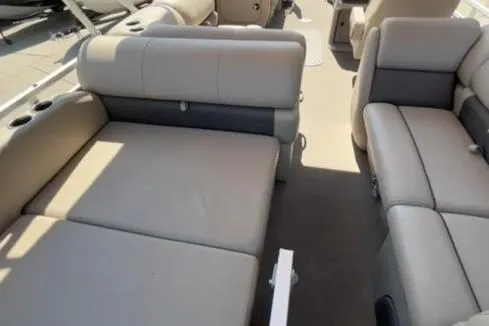 Slide: The Image of 2026 Sun Tracker Party Barge 22 RF XP3 interior with beige seating and cup holders. - 12