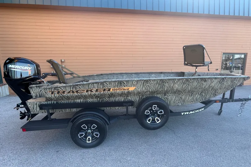 The Image of 2026 Tracker Grizzly 1756 T Marsh boat with camo design and Mercury engine. - 0