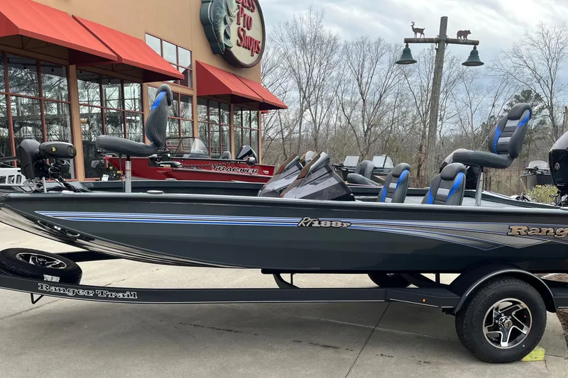 The Image of 2026 Ranger RT188P boat displayed outside Bass Pro Shops, featuring sleek design and modern seating. - 0