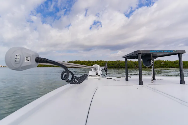 Slide: The Image of 2026 Broadwater 25 Bay Cat boat on calm water with clear sky. - 19