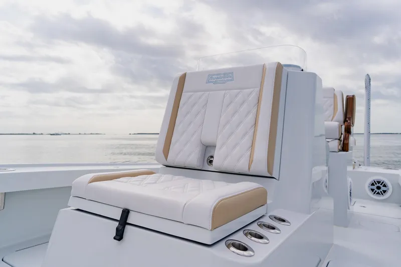 Slide: The Image of Luxurious seating on 2026 Broadwater 25 Bay Cat boat with ocean backdrop. - 24