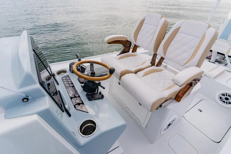 Slide: The Image of Luxurious helm seating on 2026 Broadwater 25 Bay Cat boat, featuring modern controls and design. - 25
