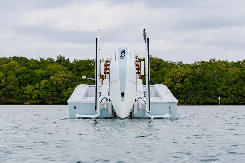 Slide: The Image of 2026 Broadwater 25 Bay Cat boat on water, surrounded by lush greenery. - 3