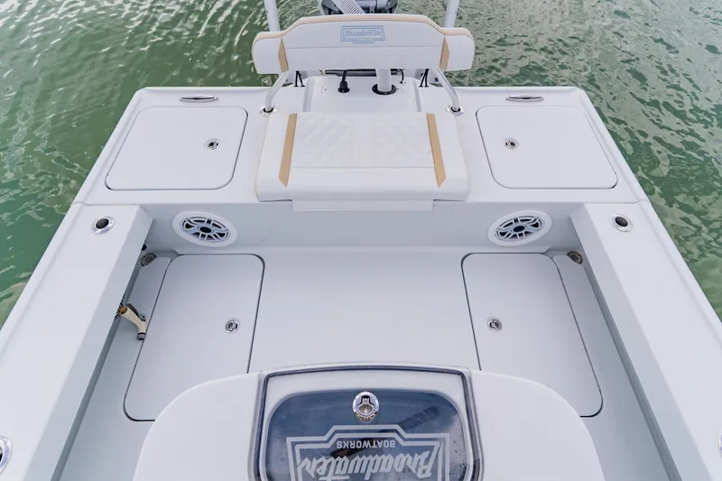 Slide: The Image of 2026 Broadwater 25 Bay Cat boat deck with storage compartments and seating. - 32