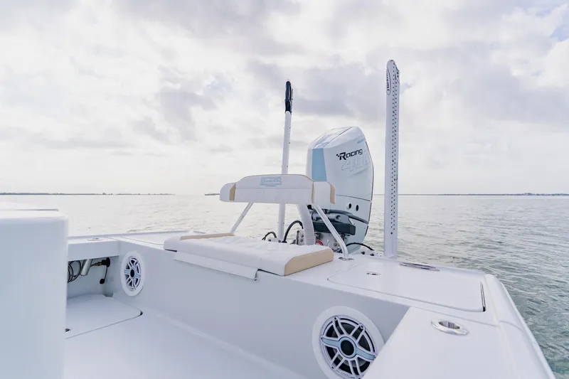 Slide: The Image of 2026 Broadwater 25 Bay Cat boat on calm water, featuring a powerful engine. - 36