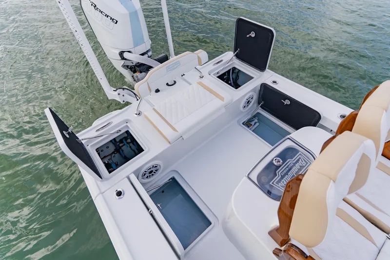 Slide: The Image of 2026 Broadwater 25 Bay Cat boat interior with open storage compartments and seating. - 37