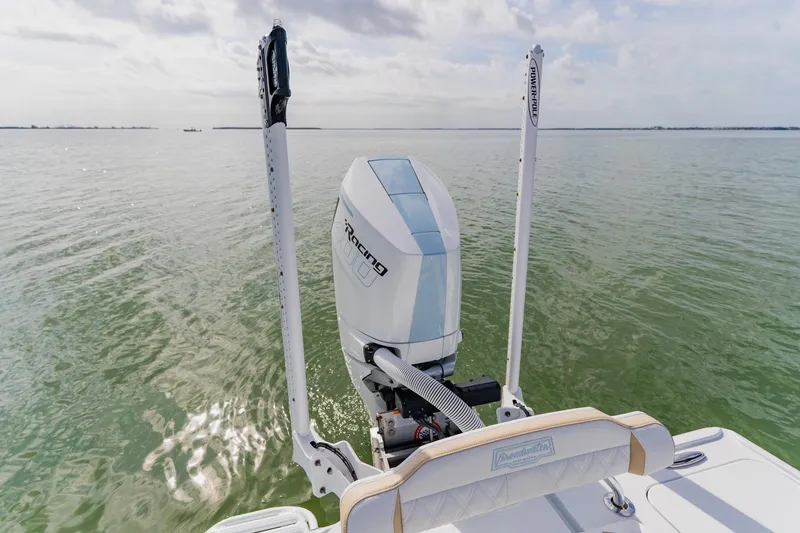 Slide: The Image of 2026 Broadwater 25 Bay Cat boat with powerful outboard motor on calm water. - 44