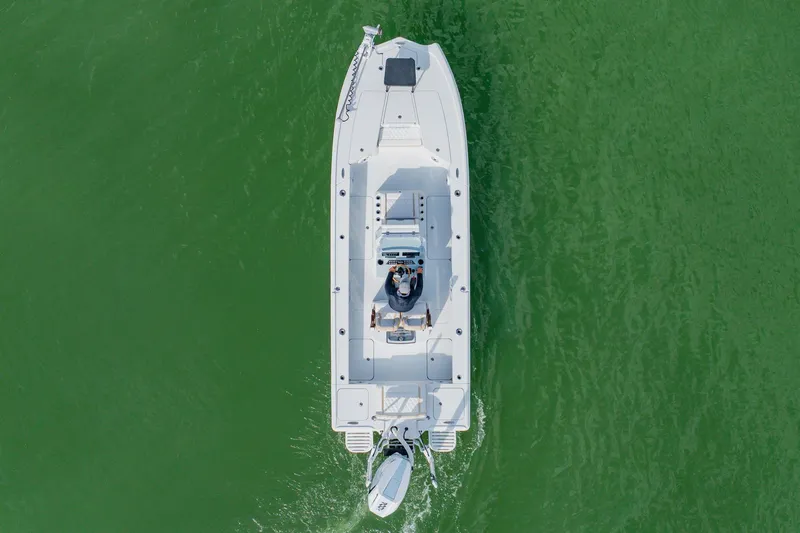 Slide: The Image of Aerial view of 2026 Broadwater 25 Bay Cat boat on green water. - 9