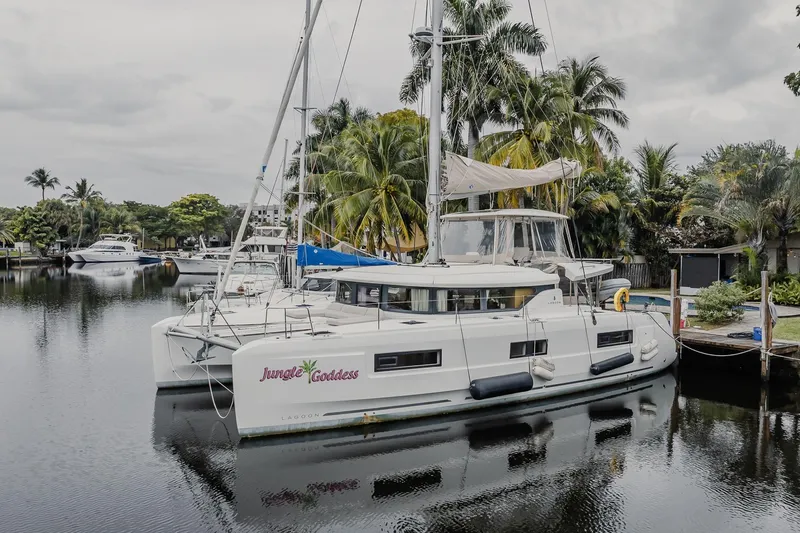The Image of 2022 Lagoon 46 catamaran "Jungle Goddess" docked by palm trees in a serene marina. - 0