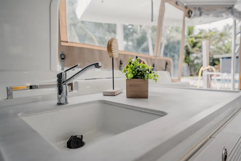 Slide: The Image of Modern kitchen sink on Lagoon 46 yacht, 2022 model, with plant decor. - 10