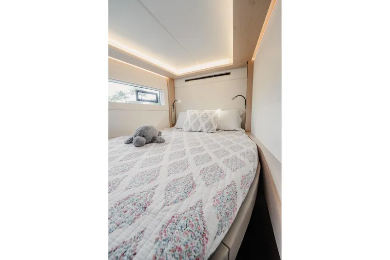 Slide: The Image of Luxurious bedroom interior of 2022 Lagoon 46 yacht with elegant bedding and soft lighting. - 100