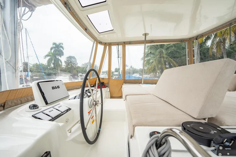 Slide: The Image of Interior view of 2022 Lagoon 46 catamaran cockpit with steering wheel and seating. - 101