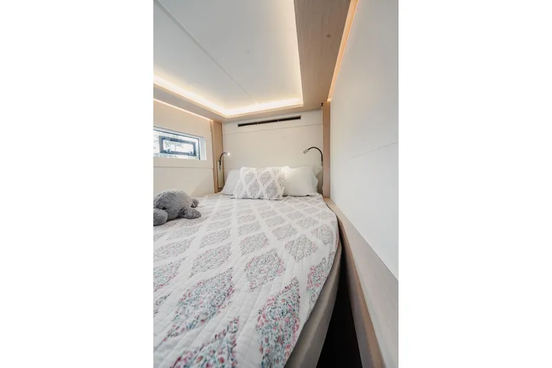 Slide: The Image of Luxurious bedroom interior of 2022 Lagoon 46 yacht with elegant bedding and soft lighting. - 103