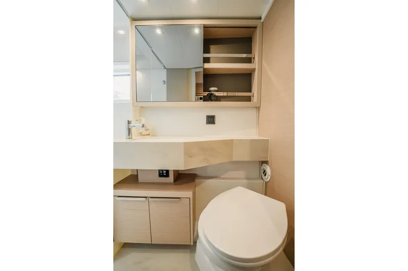 Slide: The Image of Modern bathroom interior of 2022 Lagoon 46 yacht, featuring sleek design and wooden cabinetry. - 107