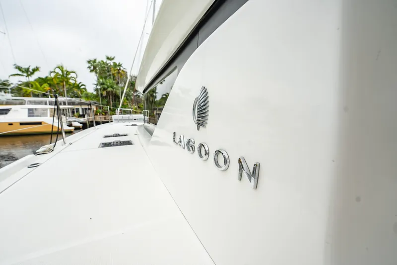 Slide: The Image of 2022 Lagoon 46 catamaran docked, showcasing sleek design and branding. - 11