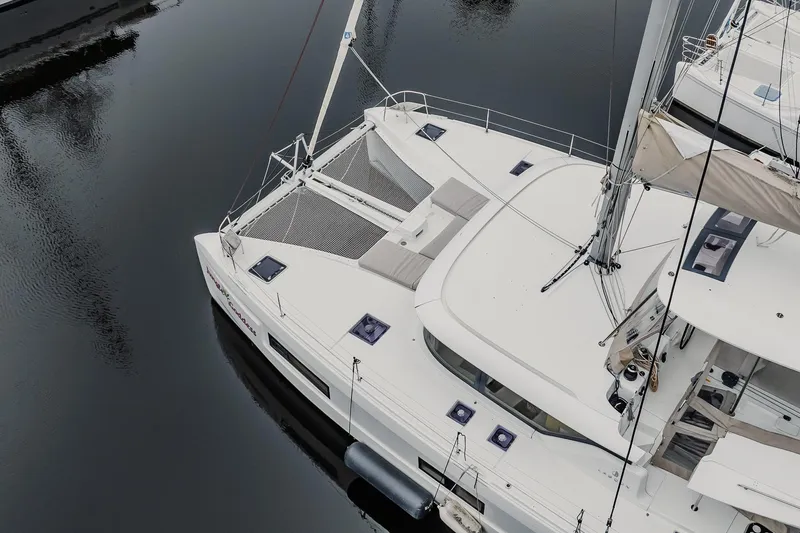 Slide: The Image of Aerial view of 2022 Lagoon 46 catamaran docked on calm water. - 110