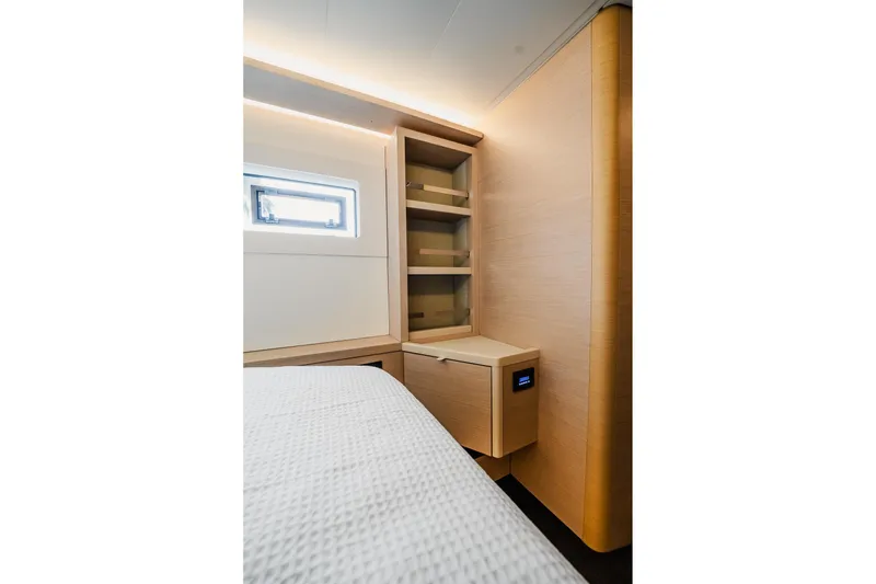 Slide: The Image of Interior of 2022 Lagoon 46 yacht with modern wooden cabinetry and window. - 118