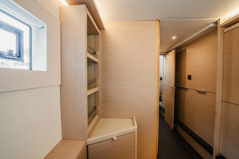 Slide: The Image of Interior of 2022 Lagoon 46 yacht, featuring modern wood cabinetry and sleek design. - 121