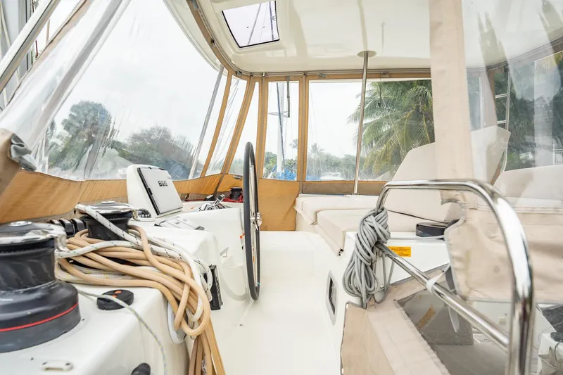 Slide: The Image of Interior view of 2022 Lagoon 46 catamaran cockpit with steering wheel and seating area. - 122