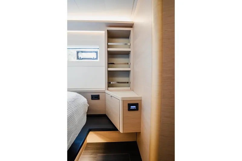 Slide: The Image of Modern interior of 2022 Lagoon 46 yacht with sleek wooden cabinetry and shelving. - 123