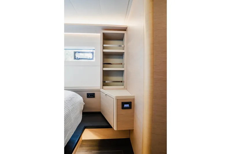Slide: The Image of Modern interior of 2022 Lagoon 46 yacht with sleek wooden cabinetry and shelving. - 131