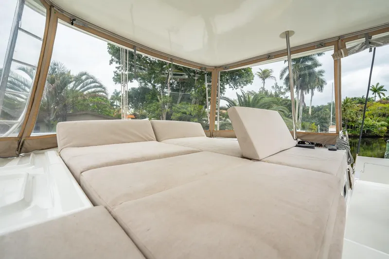 Slide: The Image of 2022 Lagoon 46 yacht interior with beige seating and tropical view. - 133