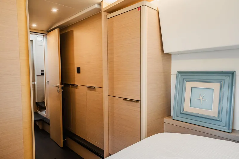Slide: The Image of Interior of 2022 Lagoon 46 yacht with modern wood finish and starfish artwork. - 134
