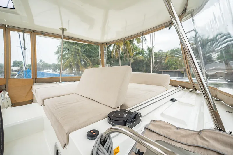 Slide: The Image of Interior of 2022 Lagoon 46 catamaran with beige seating and panoramic windows. - 138