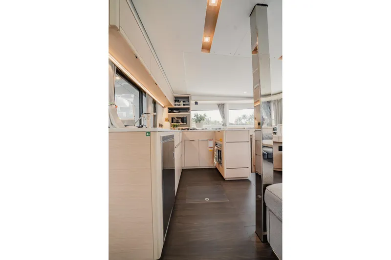 Slide: The Image of Modern interior of 2022 Lagoon 46 yacht, featuring sleek kitchen design and ample natural light. - 14