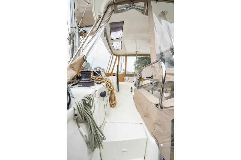 Slide: The Image of 2022 Lagoon 46 yacht cockpit with ropes and winch, featuring clear canopy. - 140